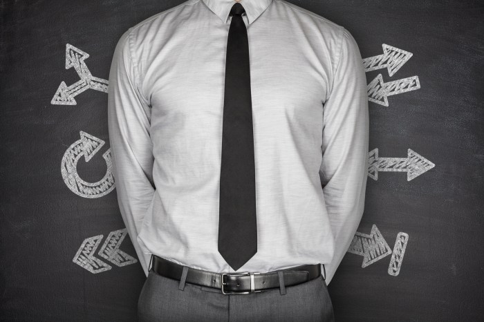 Arrows concept with businessman on Blackboard